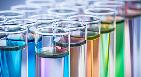 Scientist dropping droplets into flask
